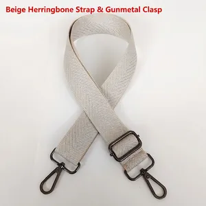 Detail of beige chevron strap with silver threads and gunmetal hardware lobster clips