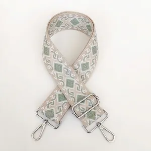 Close-up of diamond pattern jacquard canvas bag strap with adjustable silver hook