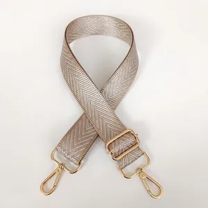 Adjustable khaki canvas strap with silver thread V-pattern and gold metal hooks