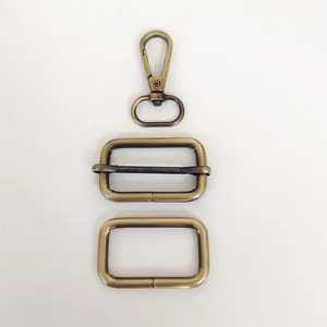 Close-up of vintage bronze hardware set including lobster clasp and adjustable buckle