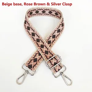 Detail of adjustable canvas strap with pink diamond pattern and silver metal hooks