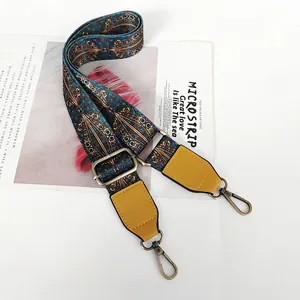 Detail of adjustable woven strap with vintage pattern and bronze metal hooks
