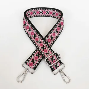 Detail of colorful geometric diamond pattern on thick canvas shoulder strap with silver hooks