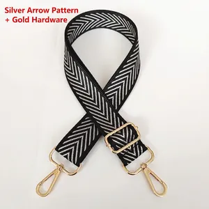 Detail of adjustable black and white herringbone strap with gold metal hooks