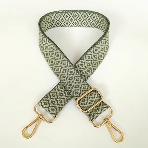 Detail of adjustable green and beige geometric diamond pattern canvas shoulder bag strap