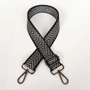 Detail of adjustable black and white silver arrow pattern bag strap with gunmetal hooks