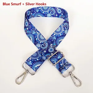 Detail view of adjustable wide shoulder strap with blue paisley print and silver metal hooks