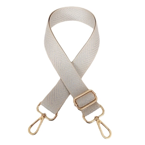 Adjustable beige woven shoulder strap with silver herringbone pattern and gold metal hooks