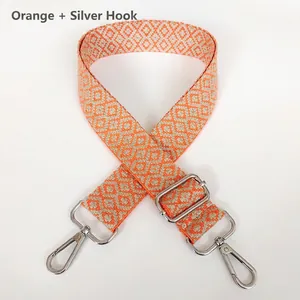 Adjustable orange and beige geometric jacquard canvas bag strap with silver metal hooks