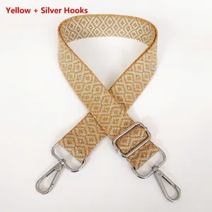Close-up of yellow jacquard canvas strap with diamond pattern and silver metal hooks