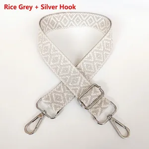 Close-up of beige-grey canvas strap with silver hardware and jacquard diamond pattern
