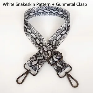 Detail of adjustable white snake print shoulder strap with gunmetal swivel hooks