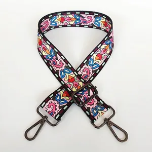 Close-up of patterned ethnic embroidery bag strap with gunmetal swivel hooks and slider