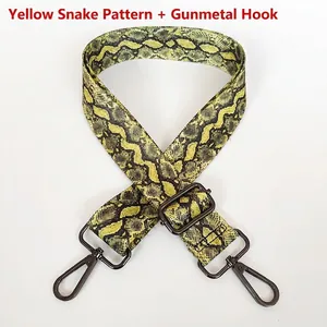 Adjustable crossbody strap featuring yellow snake pattern with gunmetal swivel hooks
