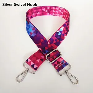 Detail of adjustable wide shoulder strap with colorful geometric pattern and silver hooks