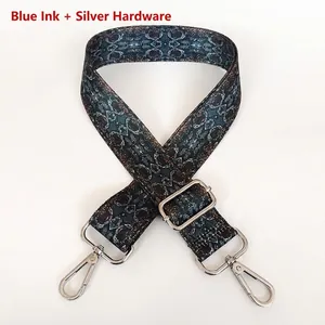 Adjustable geometric woven bag strap in dark blue and red with silver metal buckles