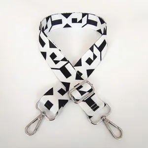 Adjustable wide replacement bag strap with black and white geometric pattern and silver hooks