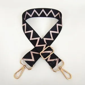 Adjustable wide replacement bag strap with black and beige chevron patterns and gold hooks