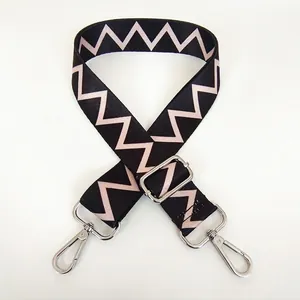Detail of 5cm wide black shoulder strap with white zigzag pattern and silver lobster hooks