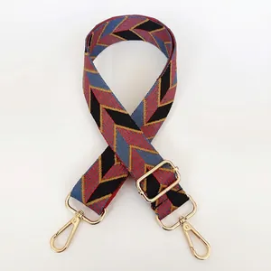 Adjustable wide canvas strap for handbags with geometric V-pattern and gold metal buckles
