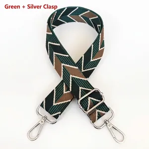 Close-up of adjustable green chevron canvas bag strap with silver metal swivel hooks