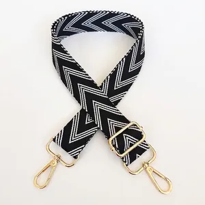 Adjustable black and white chevron canvas shoulder strap with gold-tone hooks