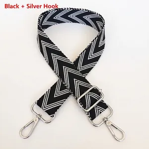 Detail of adjustable black and white V-patterned wide strap with silver metal hooks