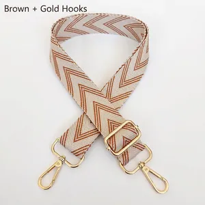Adjustable wide woven shoulder strap with brown geometric pattern and gold metal hooks