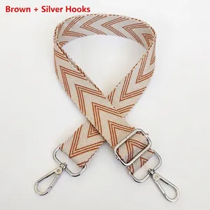 Detail of herringbone weave strap in brown and silver hooks with metal adjustment buckle