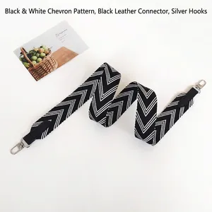 Detailed view of black and white herringbone wide strap with black leather and silver hooks
