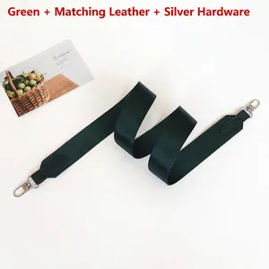 Detail view of dark green woven bag strap with matching leather ends and silver hooks