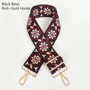 Detailed view of bohemian style black and red bag strap with gold metal swivel hooks