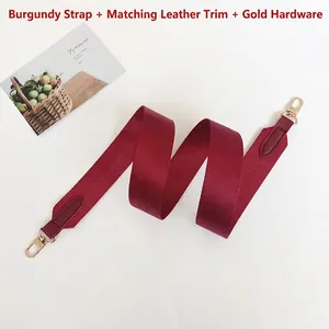 Detail of burgundy replacement shoulder strap with gold metal hooks and leather ends