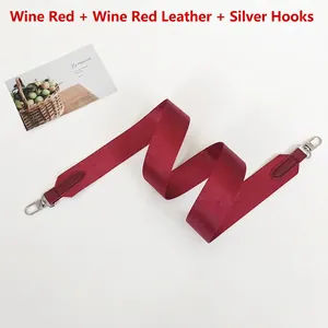 Detail of adjustable wine red crossbody bag strap with silver metal swivel hooks