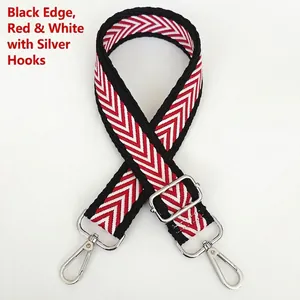 Detail view of red, white, and black herringbone strap with silver metal swivel hooks