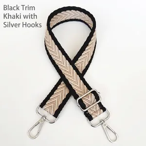 Detail of adjustable khaki chevron canvas bag strap with silver metal swivel hooks