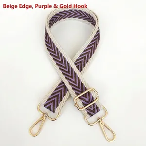 Macro detail of beige and purple chevron canvas strap with shiny gold metal hooks
