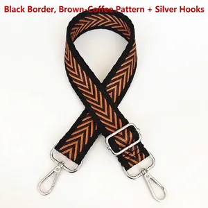 Detail view of woven arrow pattern canvas bag strap with silver metal lobster clasps