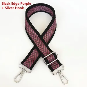 Detail of adjustable woven purse strap with purple V-shaped pattern and silver hardware