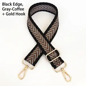 Close-up of chevron woven wide bag strap with black and grey coffee pattern and gold metal hooks