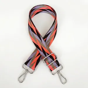Detail of adjustable geometric strap with silver swivel hooks for handbags