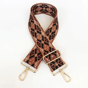 Close-up of bohemian geometric jacquard bag strap with golden metal swivel snap hooks