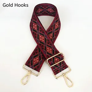 Close-up of vintage geometric jacquard bag strap with gold lobster clasps and buckles