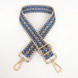 Detail of adjustable thick canvas bag strap with blue and khaki geometric diamond pattern
