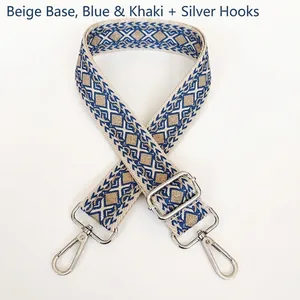 Detail of wide woven canvas strap with beige blue khaki geometric pattern and silver hooks