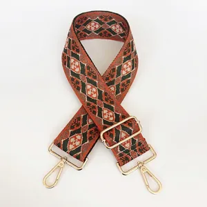 Geometric woven strap with orange and green patterns and gold lobster clasps