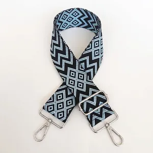 Detail of durable nylon replacement bag strap with blue patterns and silver hooks
