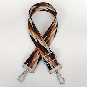 Adjustable geometric patterned bag strap with silver metal hooks and retro woven fabric