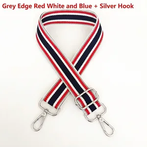 Detail of red white and blue striped nylon bag strap with silver metal swivel hooks