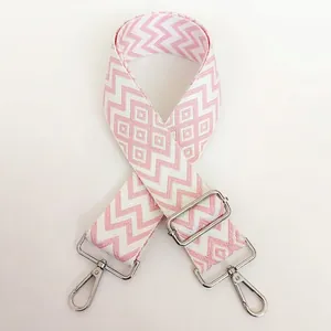 Close-up of pink wave pattern nylon bag strap with silver metal swivel lobster hooks